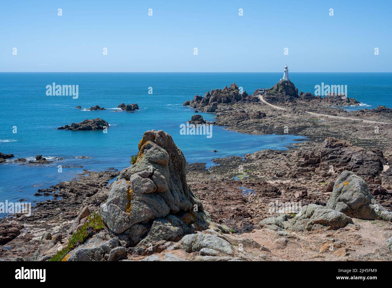 La Corbiere lighthouse on the headland of St Brelade in the south-west of the British Crown Dependency of Jersey, Channel Islands, British Isles. Stock Photo