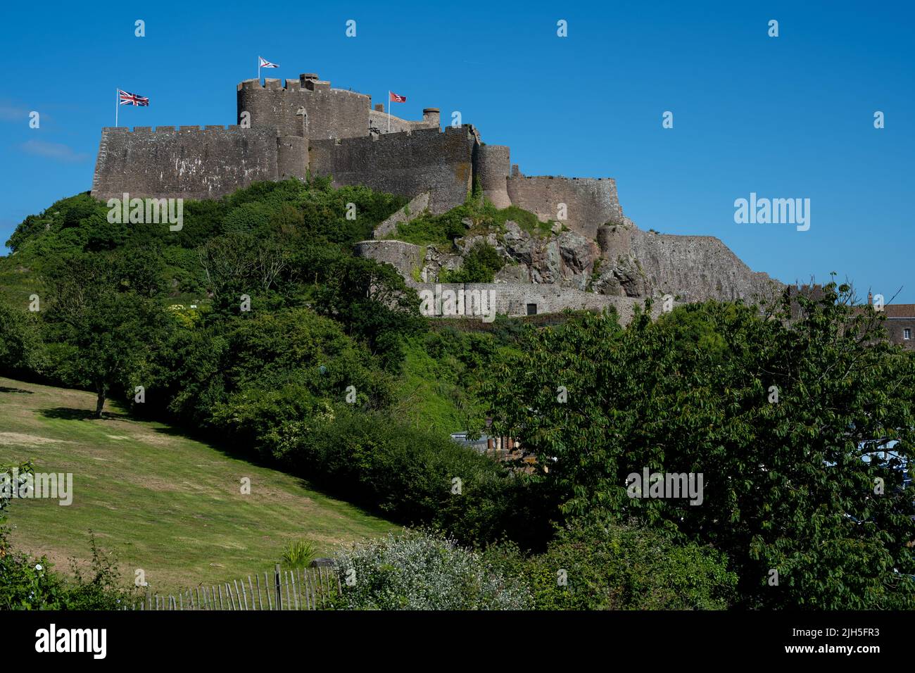 The iconic Mont Orgueil Castle guarding the entrance to Gorey harbour of the British Crown Dependency of Jersey, Channel Islands, British Isles. Stock Photo