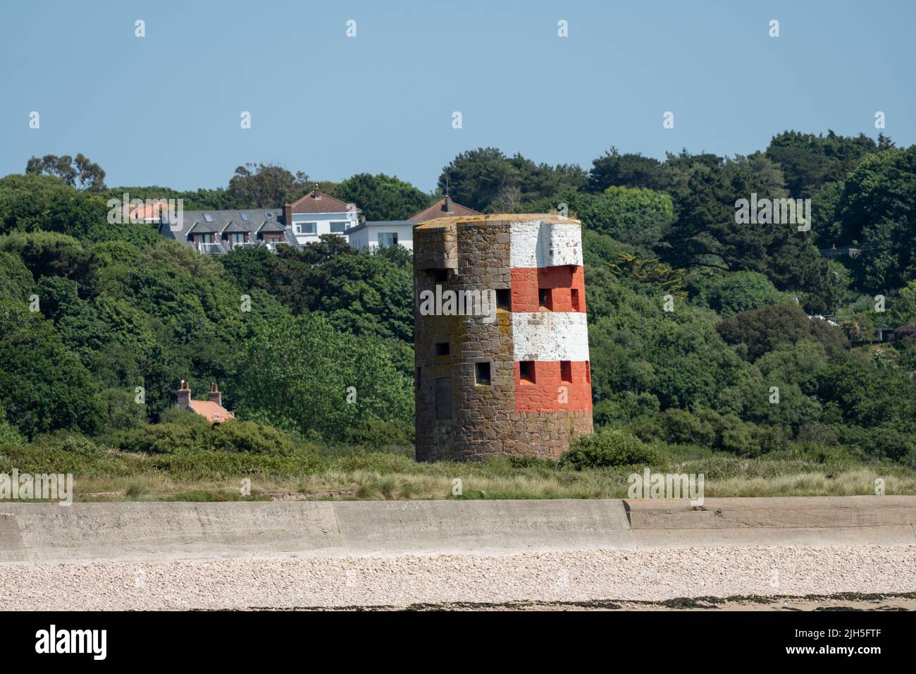 St Brelade's bay WW2 watchtower on the headland of St Brelade in the south-west of the British Crown Dependency of Jersey, Channel Islands Stock Photo