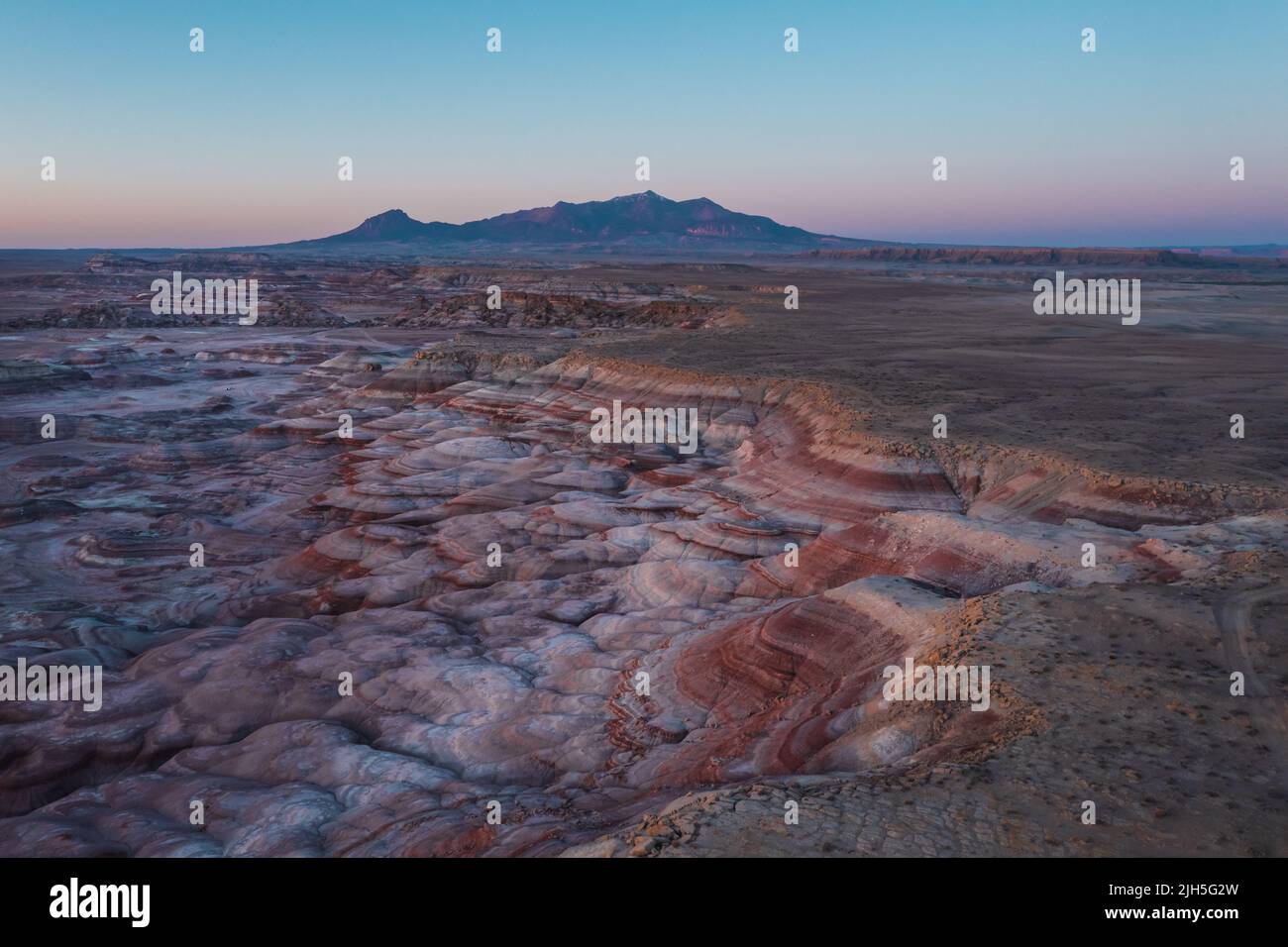 Moonscape landscape in Utah. Red rocks glow at sunrise Stock Photo