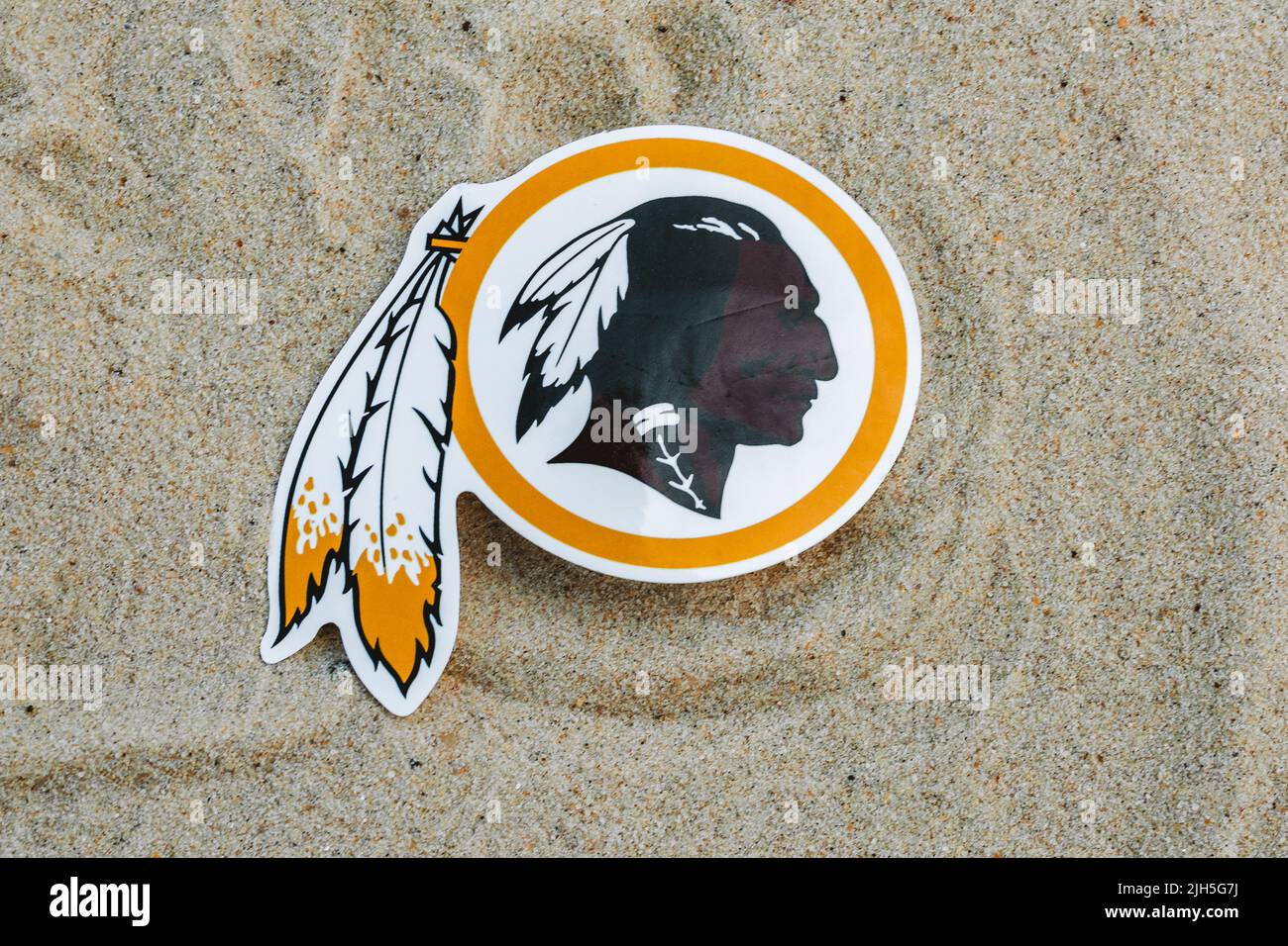 September 15, 2021, Moscow, Russia. The emblem of the Washington Redskins football club on the sand of the beach. Stock Photo