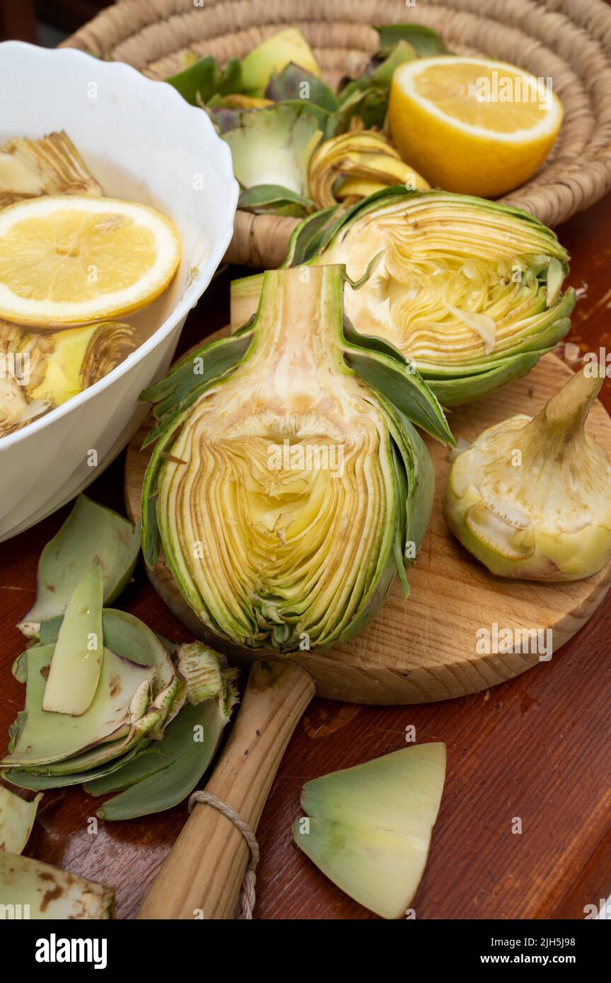 Cooking of green heads of artichokes plants, how to peel raw artichoke
