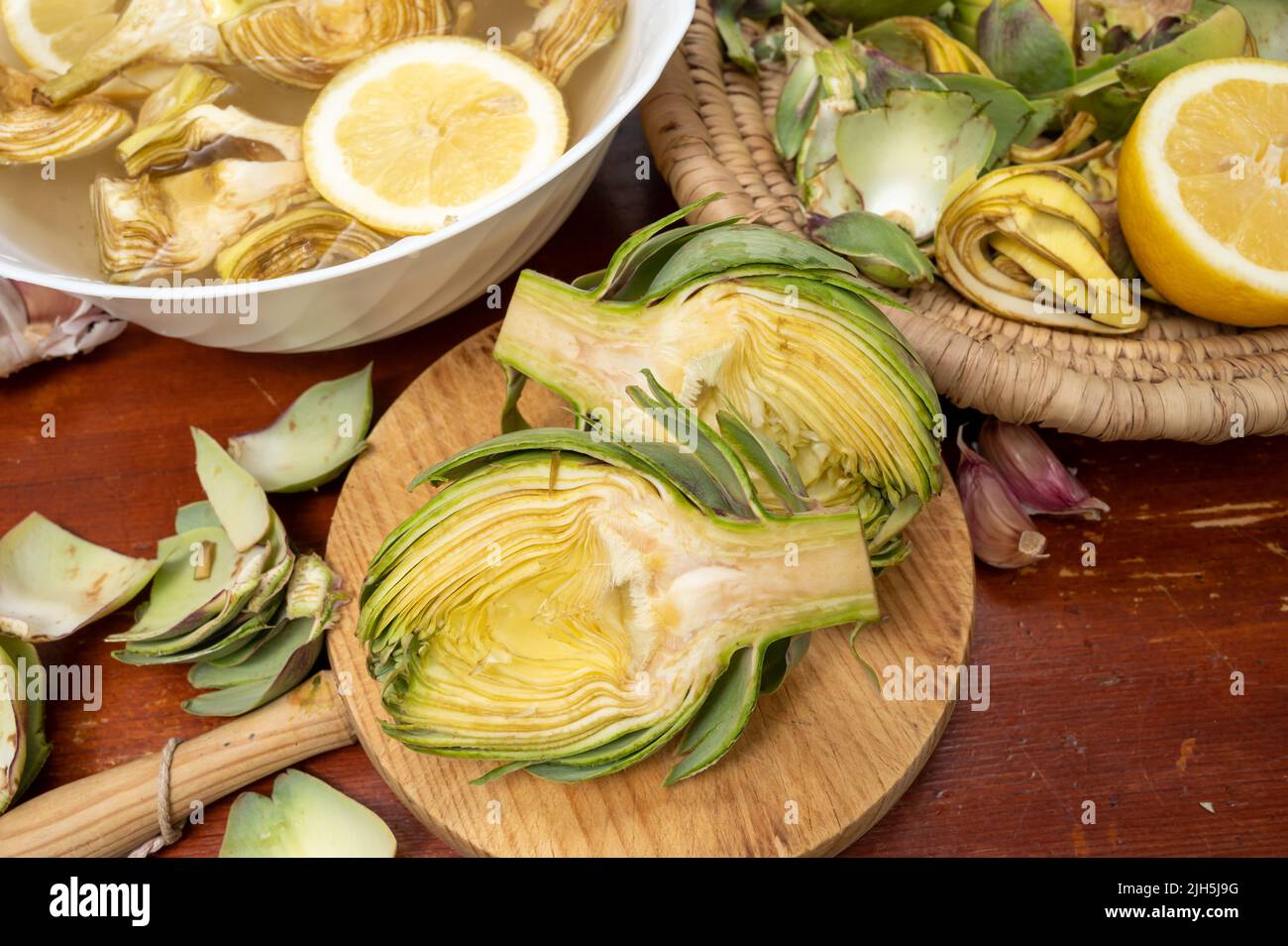 Cooking of green heads of artichokes plants, how to peel raw artichoke