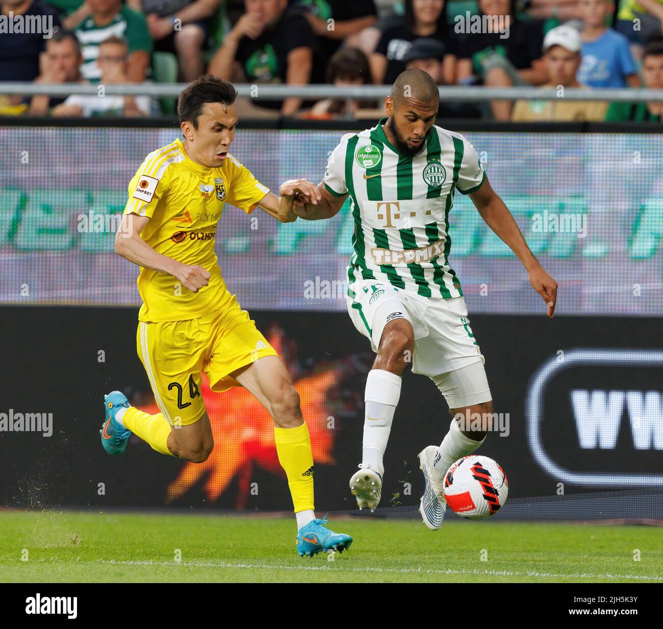 BUDAPEST, HUNGARY - JULY 13: Aleksa Amanovic of FC Tobol challenges  Kristoffer Zachariassen of Ferencvarosi TC during the UEFA Champions League  2022/23 First Qualifying Round Second Leg match between Ferencvarosi TC and