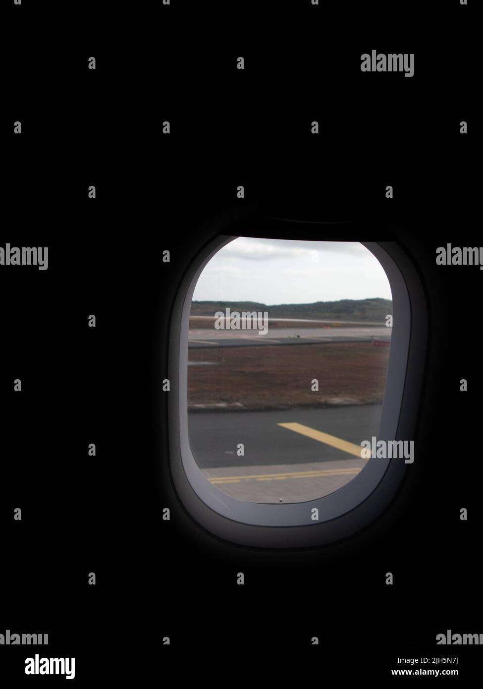 An Aeroplane Window - looking at the tarmac Stock Photo