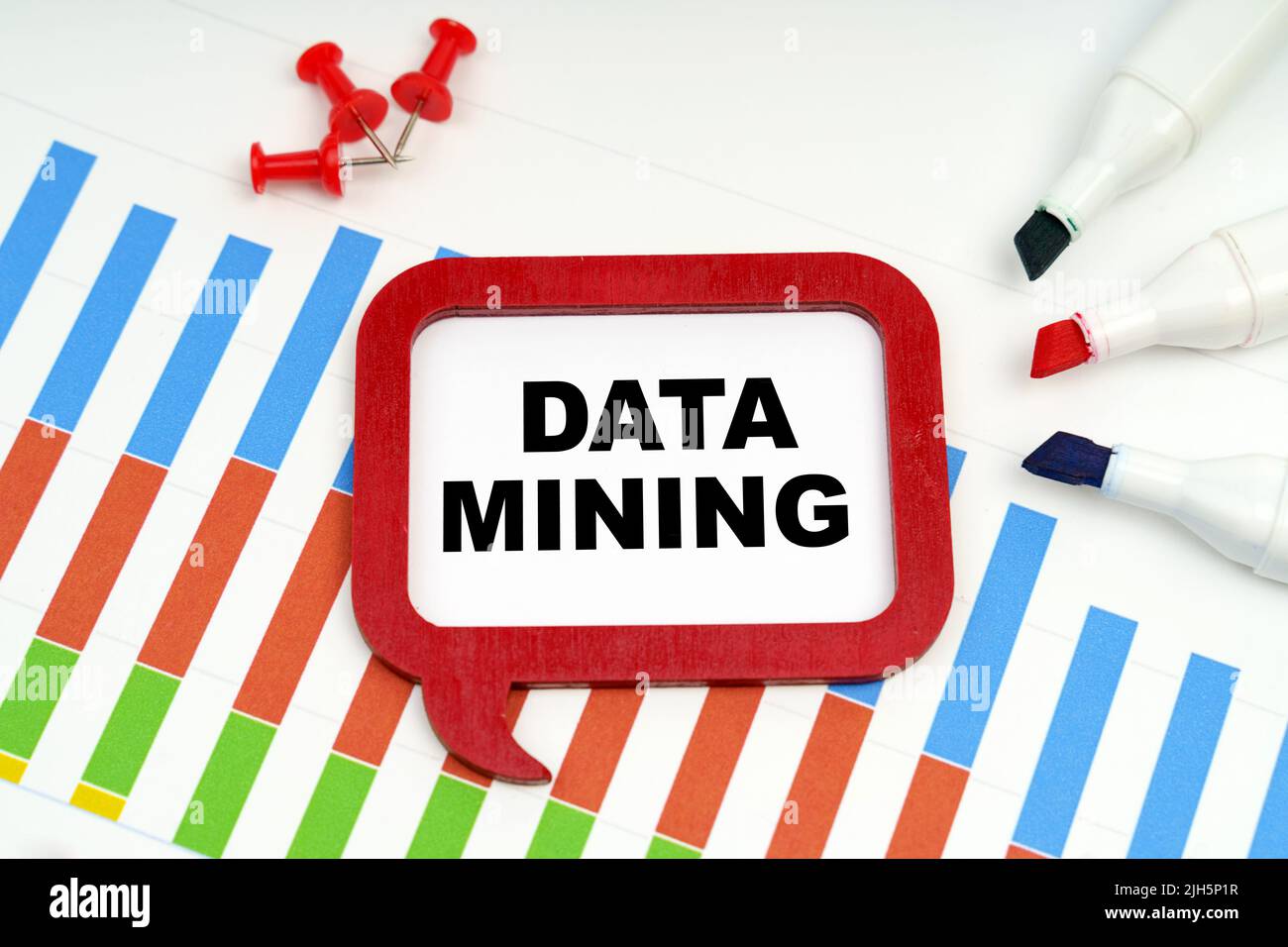 Business and economy concept. There are markers, charts and a sign on the table - DATA MINING Stock Photo