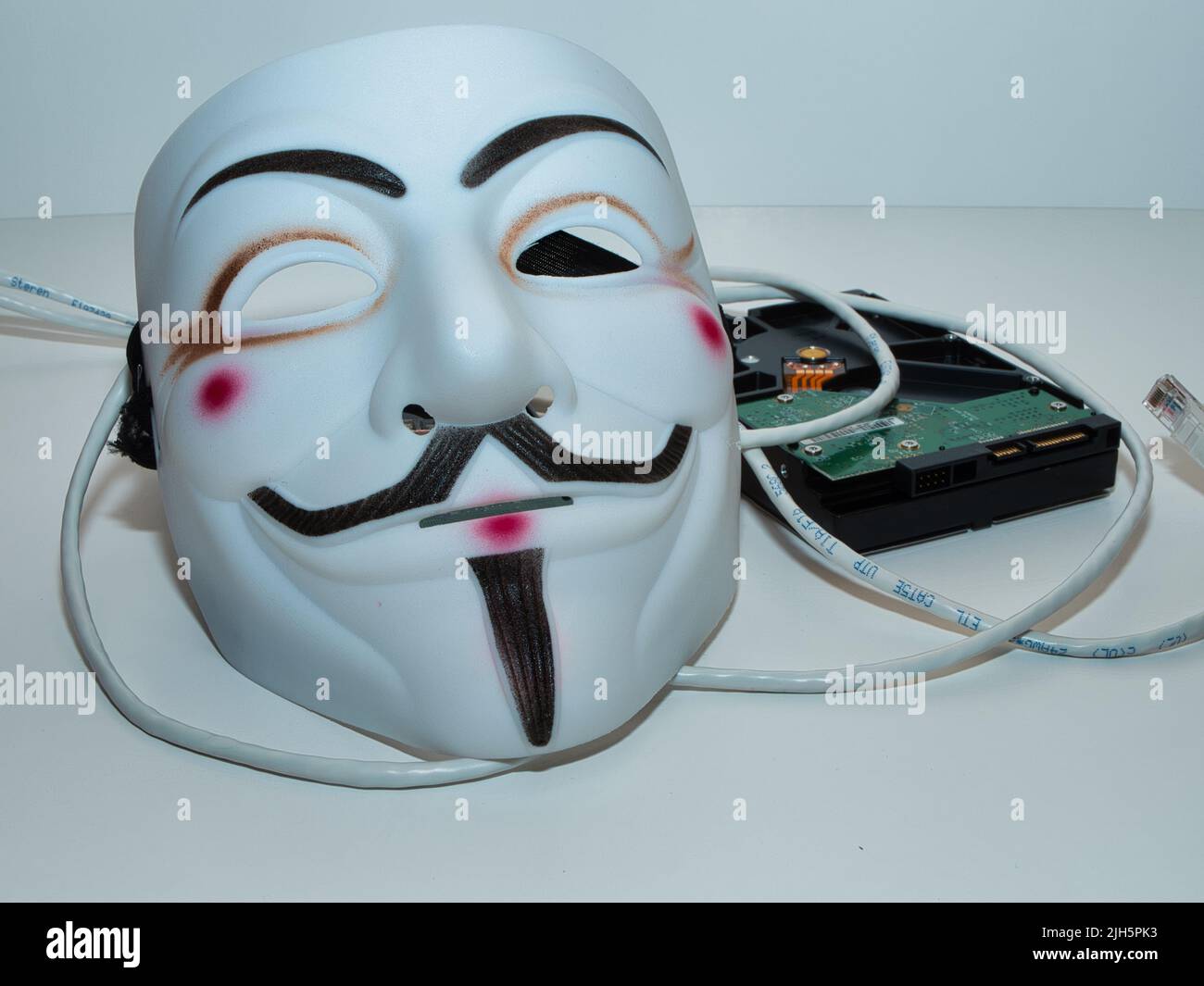 Guy Fawkes like Anonymous style hacker mask. Excellent imagery for cybersecurity application. Stock Photo