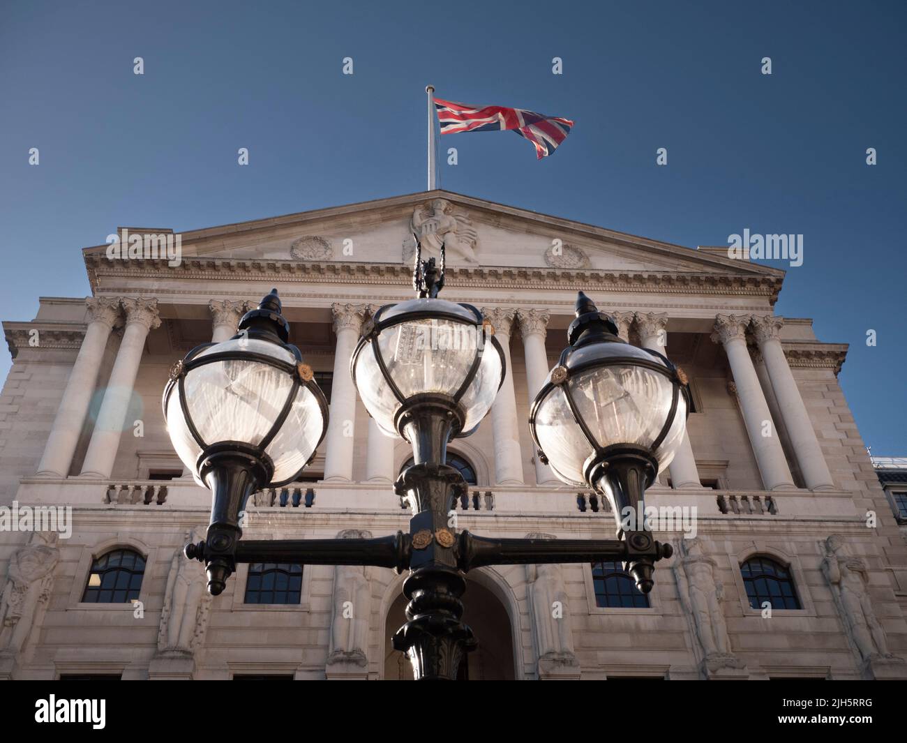 Union Jack Union Flag outside Bank of England Threadneedle Street London UK, with historic  lamp post in foreground Stock Photo