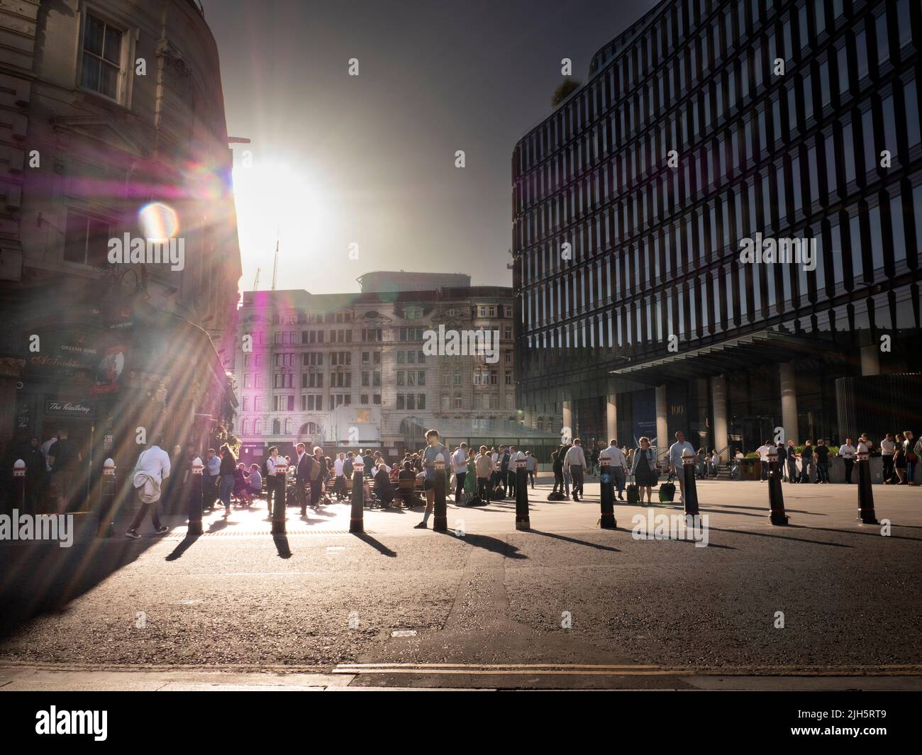 Early evening drinkers, taking refreshments during summer weather, on Piazza outside The Railway Tavern on left, Liverpool Street London Stock Photo