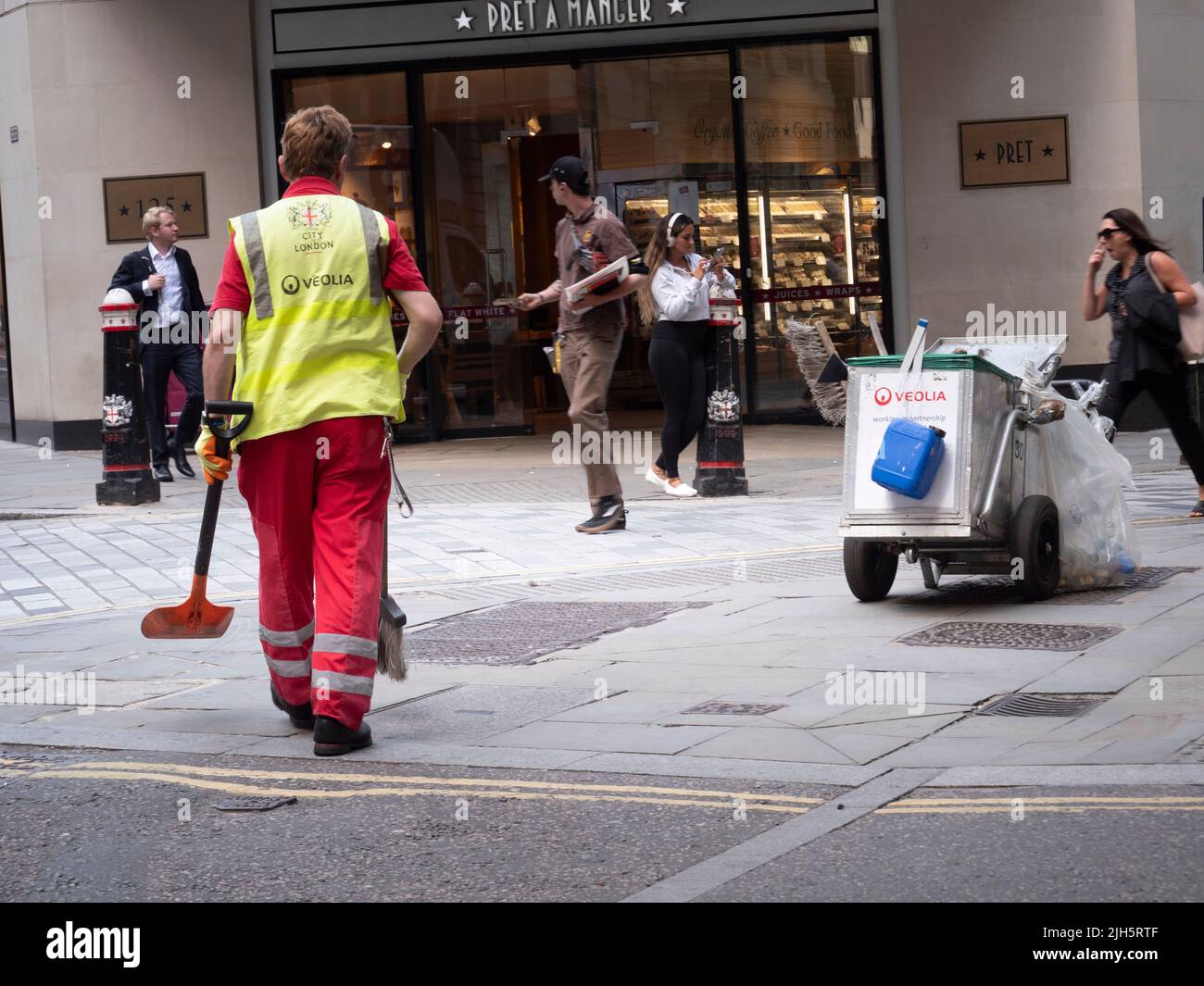 Veolia Street cleaner with brush and cart City of London UK Stock Photo