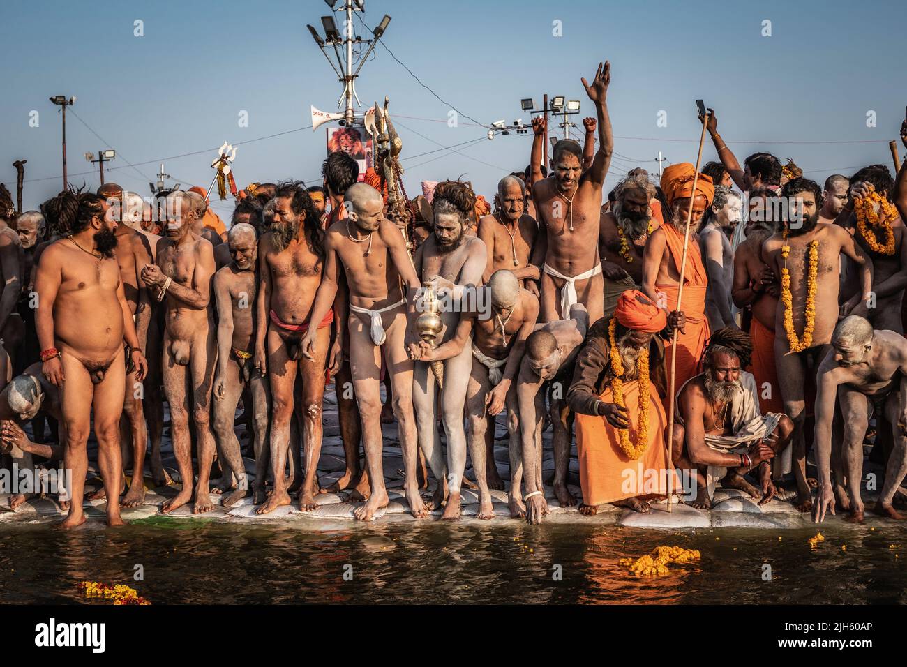 Naga Sadhus (Indian holy men) preparing to enter the sacred waters at the Sangam, Kumbh Mela Festival in Allahabad (Prayagraj), Uttar Pradesh, India. Stock Photo