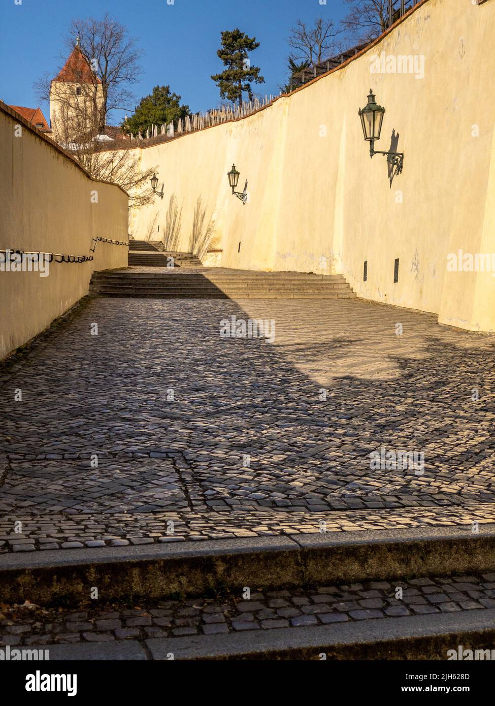 Narrow streets, stairs and wonderful palaces in Prague Castle. A unique sight without a crowd of tourists on a wonderful spring morning. Prague Castle Stock Photo