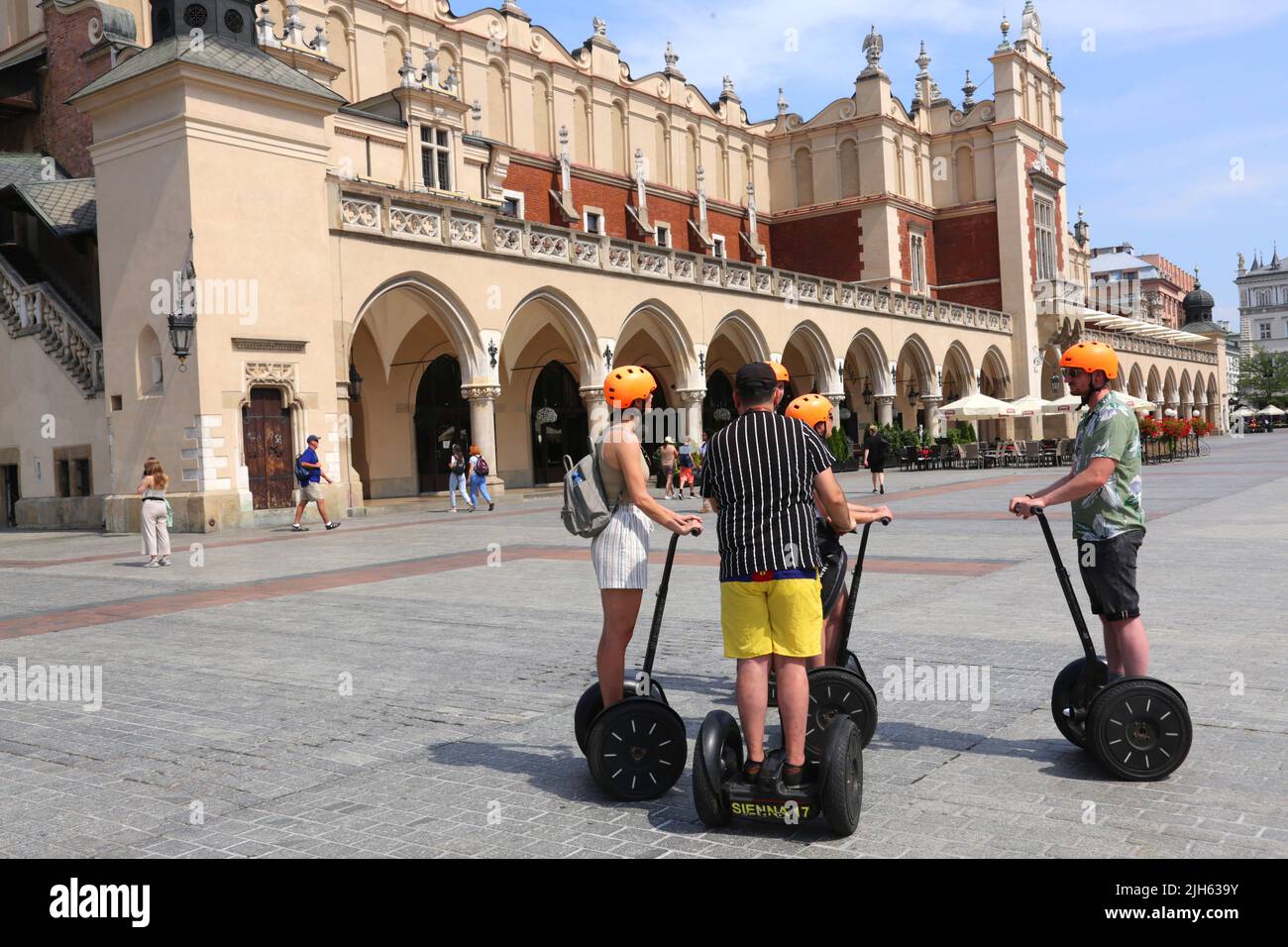 Cracow. Krakow. Poland. Group of tourists on segways with guide in front of Sukiennice Cloth Hall in the middle of Main Market Square, center of the t Stock Photo
