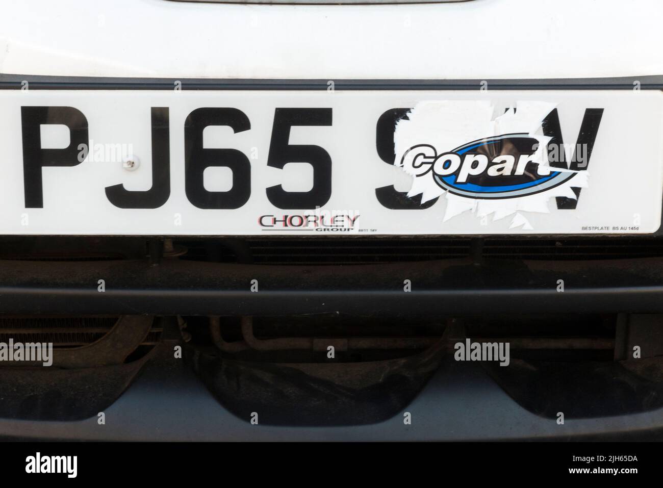 Car numberplate partially obscured by a sticker, a disguise which would