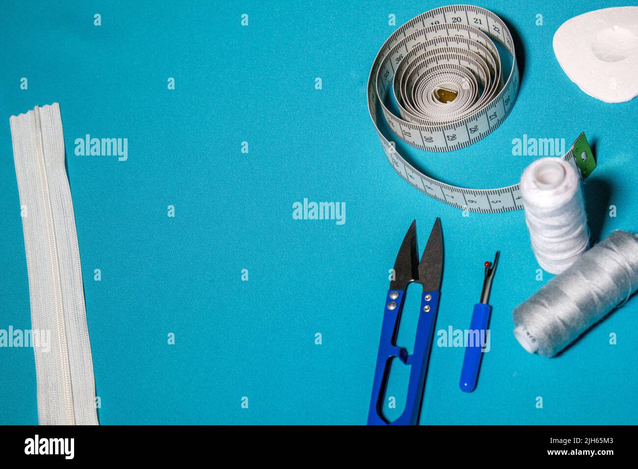 Blue textured background with sewing tools, copy space on background ...