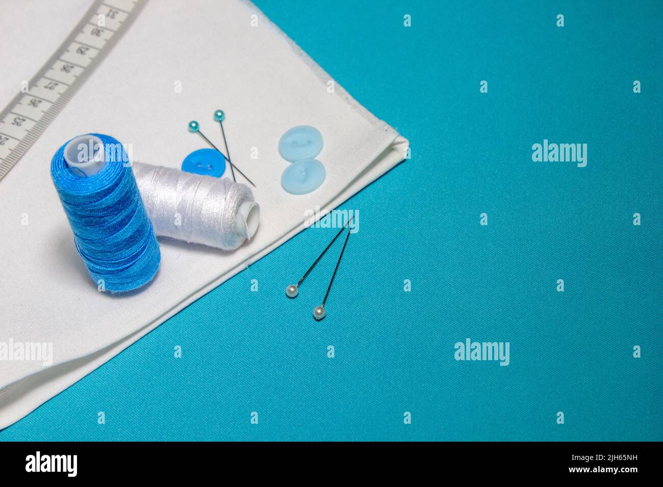 Blue textured background with sewing tools, copy space on background ...
