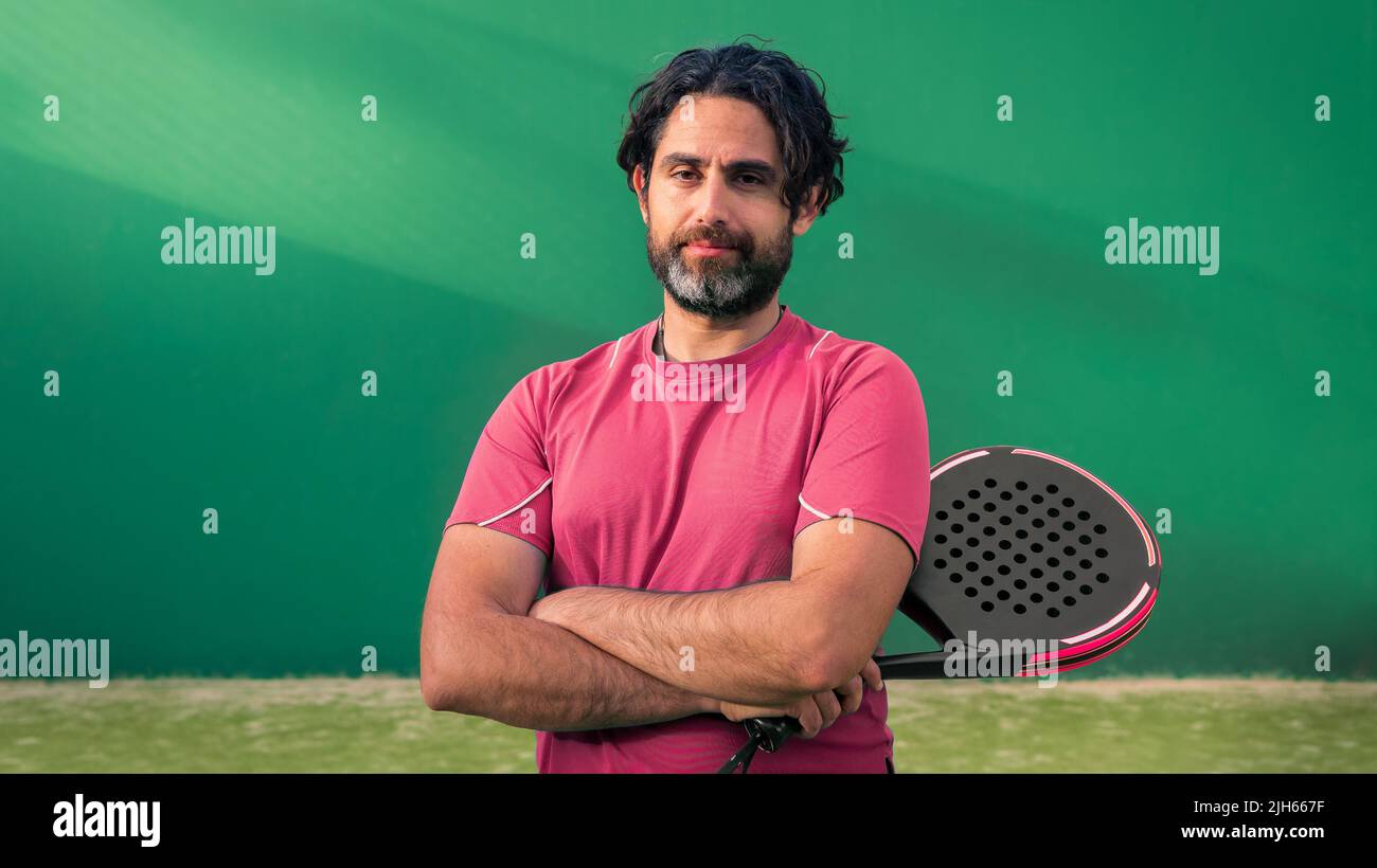 Monitor of padel holding black racket with copy space. Class to student ...