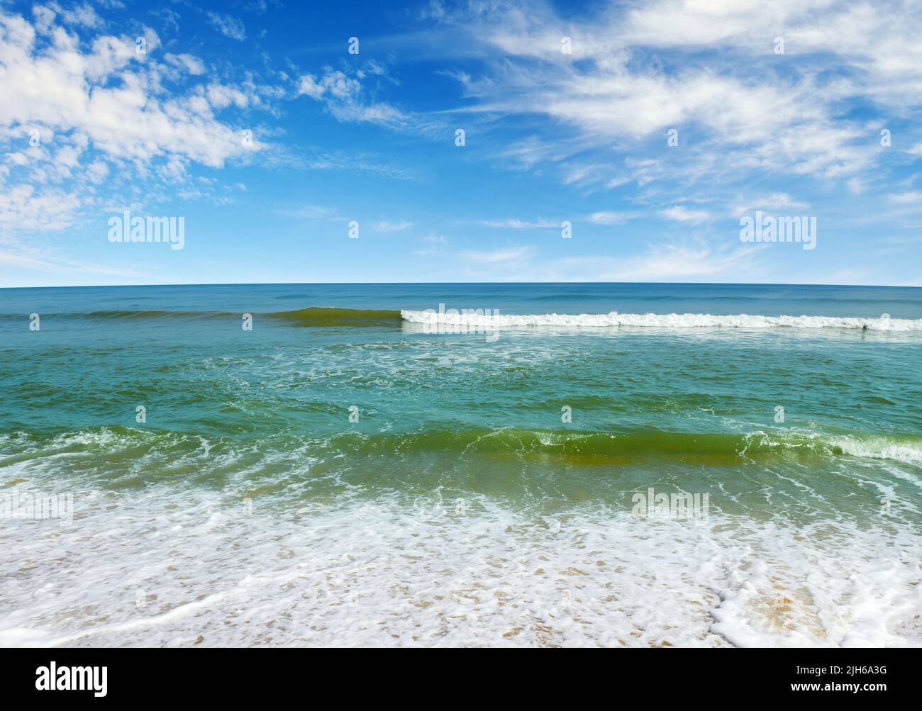 Ocean waves, yellow sand, azure sea. Tropical landscape. Stock Photo