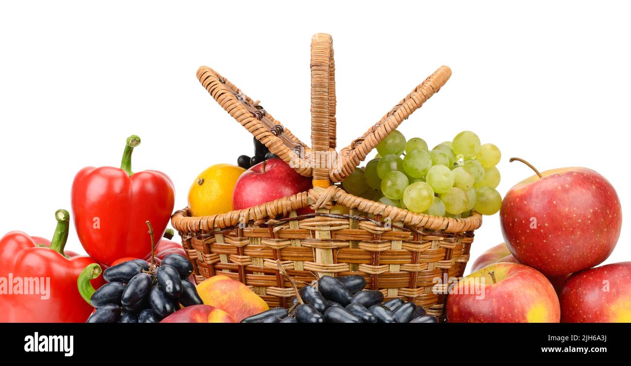 Vegetables and fruits in willow basket isolated on white background Stock Photo