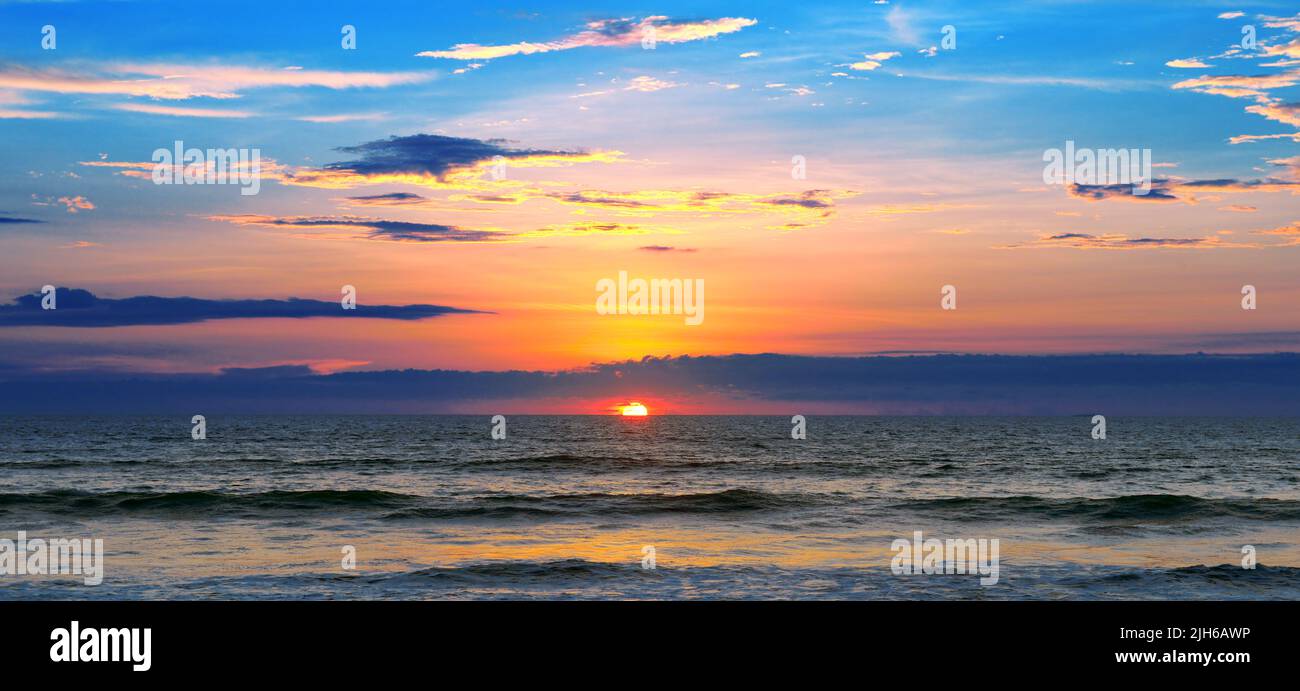 Ocean landscape with fantastic beautiful sky and calm surf Stock Photo