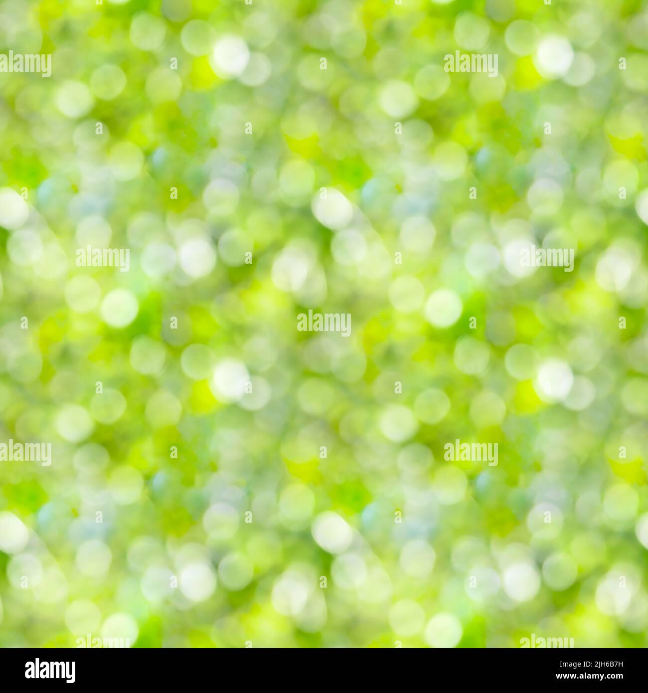 Seamless pattern. Green blurred background with sun rays. Natural texture Stock Photo