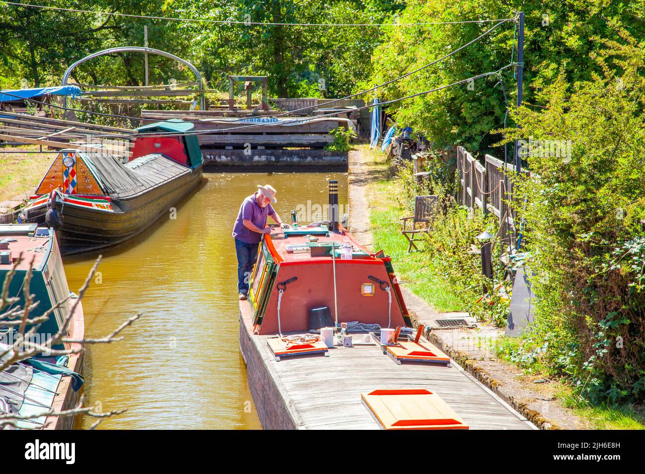Restored working canal narrow boats on the Trent and Mersey canal at Malkins Bank Canal Services Cheshire Stock Photo
