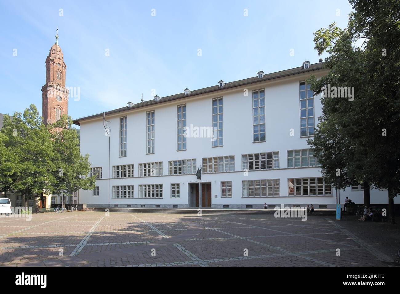 New University on University Square with the tower of the Jesuit Church in the Old Town, Heidelberg, Bergstrasse, Baden-Wuerttemberg, Germany Stock Photo