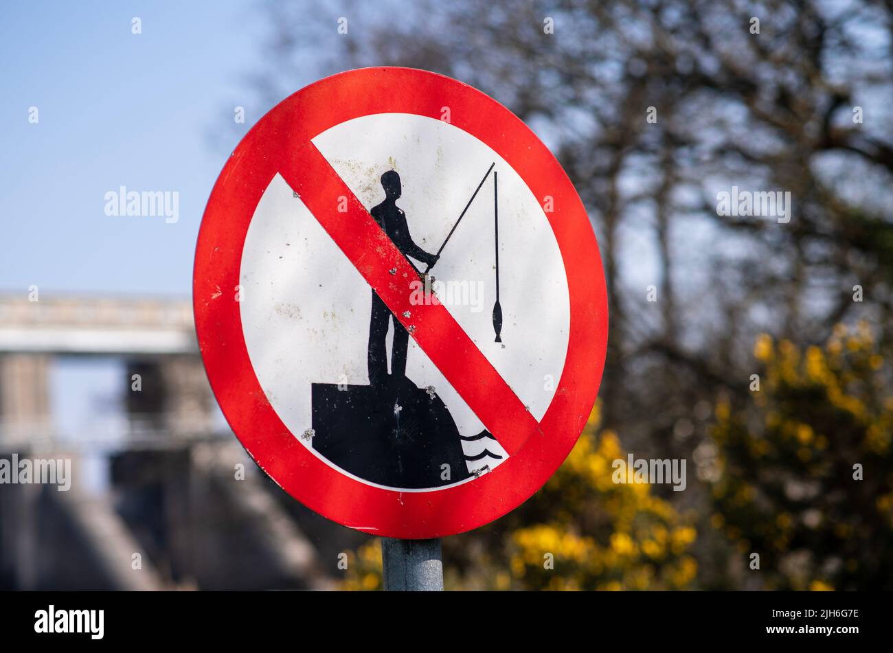 Road sign prohibiting fishing near water facility Stock Photo - Alamy