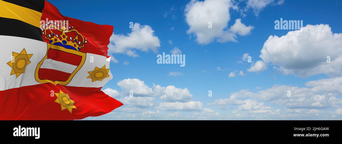 official flag of Habsburg General's Austria at cloudy sky background on sunset, panoramic view. Austrian travel and patriot concept. copy space for wi Stock Photo