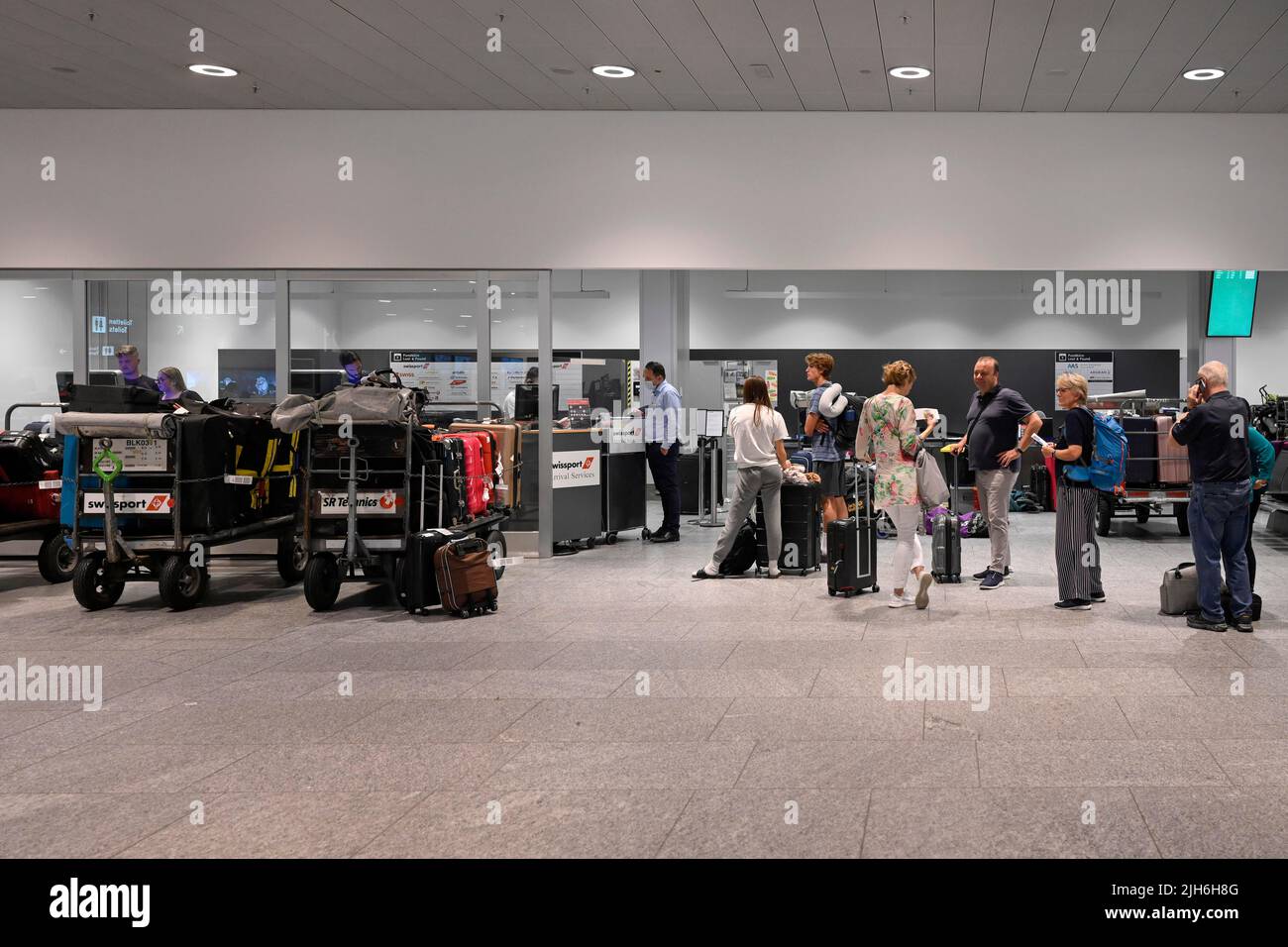 Swissport baggage handling queue, Zurich Kloten, Switzerland Stock
