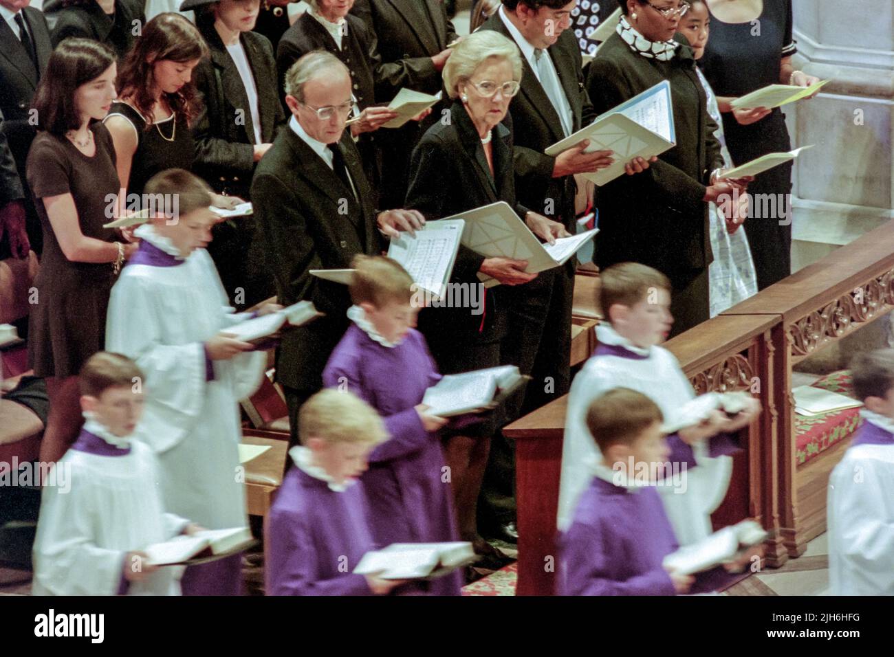 British Ambassador to the U.S. Sir John Kerr, left, joins other guests in singing a hymn during a memorial and prayer service to Diana, the Princess of Wales, on the occasion of her death at the Washington National Cathedral, September 6, 1997, in Washington, D.C. Standing next to Kerr are Chairwoman of the Washington Post Katharine Graham and U.S. ambassador to the United Nations Bill Richardson. Stock Photo