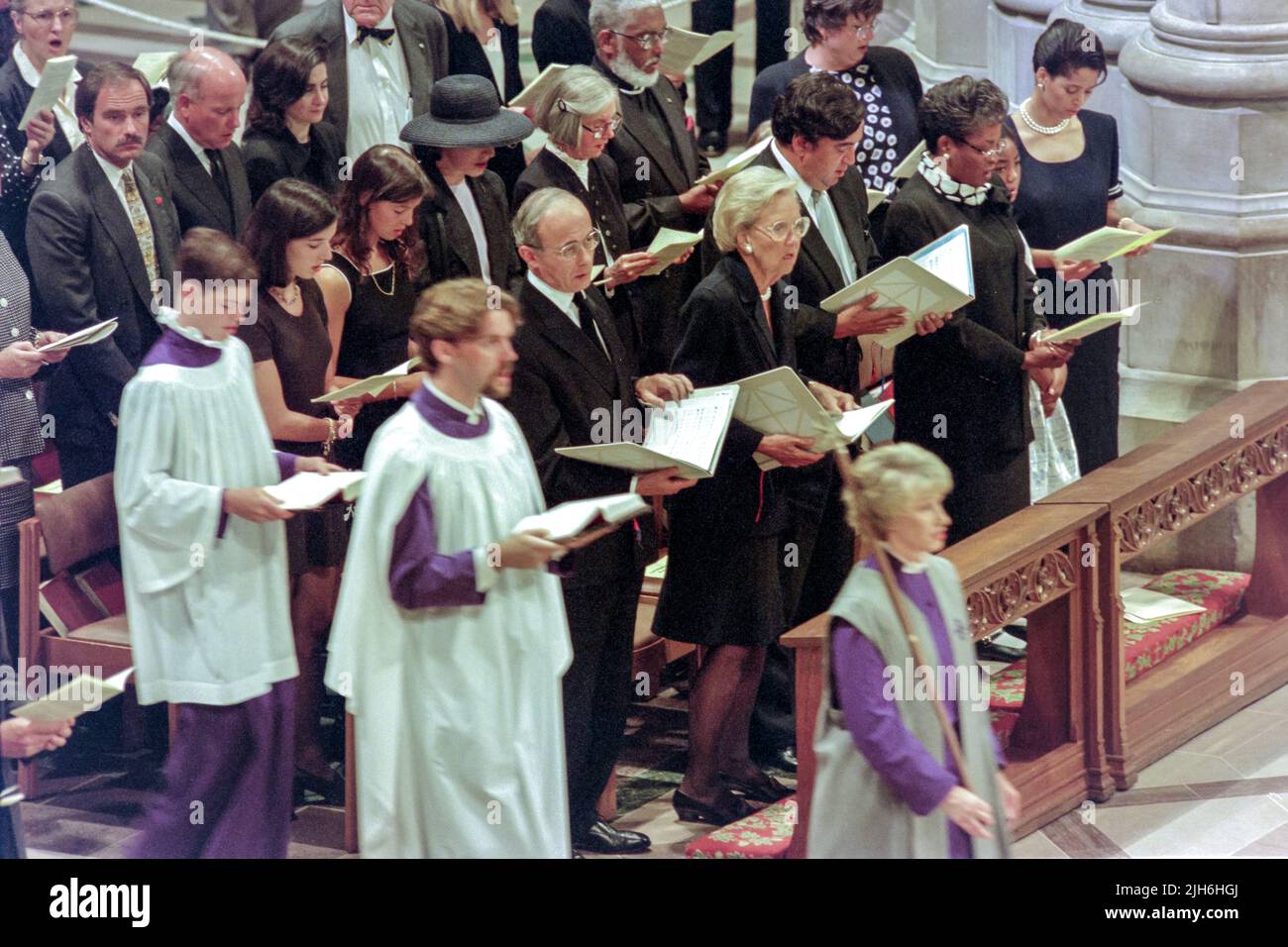 British Ambassador to the U.S. Sir John Kerr, center, joins in singing Hymn 608 during a memorial and prayer service to Diana, the Princess of Wales, on the occasion of her death at the Washington National Cathedral, September 6, 1997, in Washington, D.C. Standing next to Kerr are Chairwoman of the Washington Post Katharine Graham and U.S. ambassador to the United Nations Bill Richardson. Stock Photo