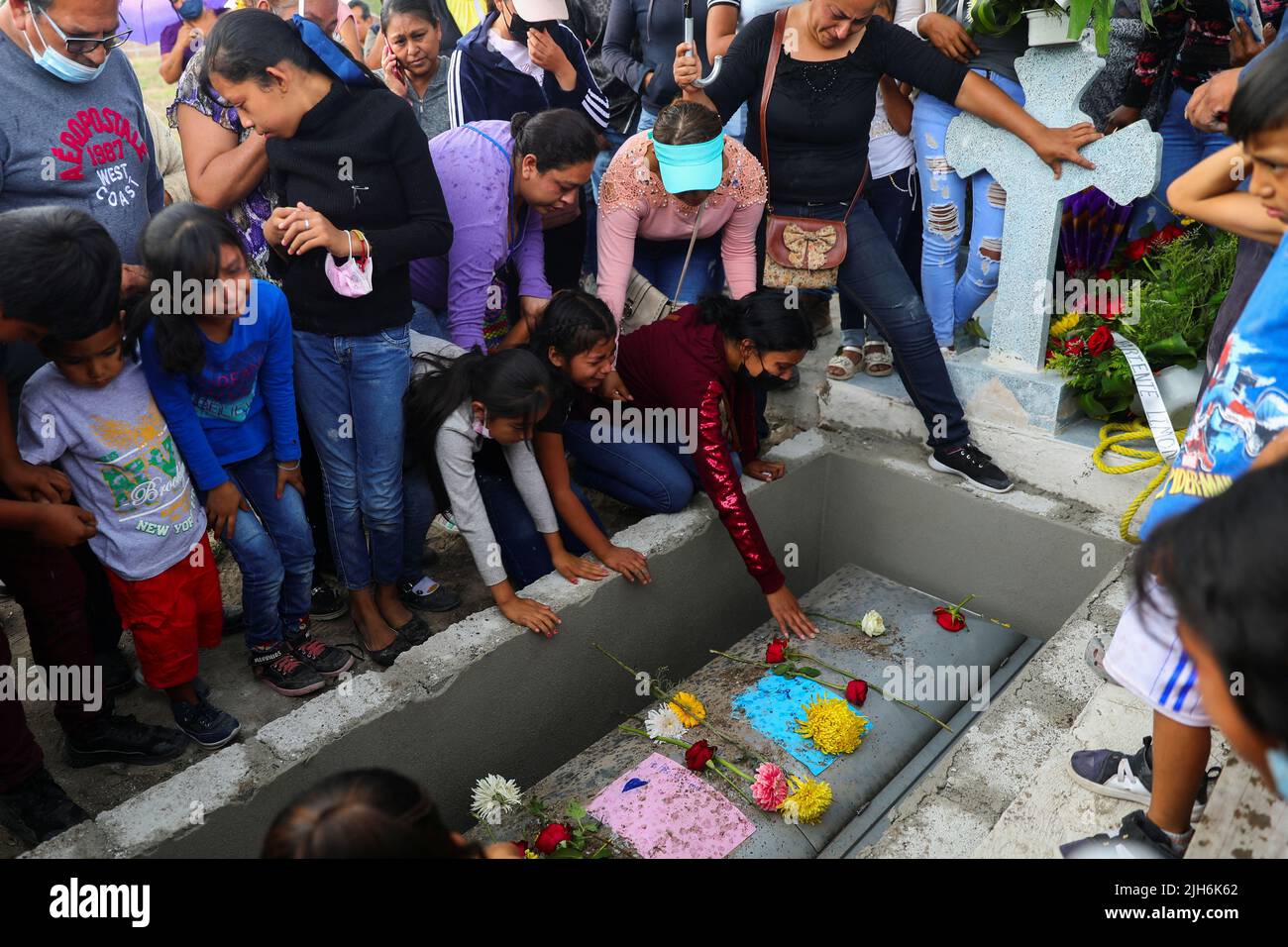 People react over the coffin of late migrant Jose Lopez, 34, who died in a trailer truck in Texas, during his burial, in Celaya, Guanajuato state, Mexico, July 15, 2022. REUTERS/Edgard Garrido Stock Photo