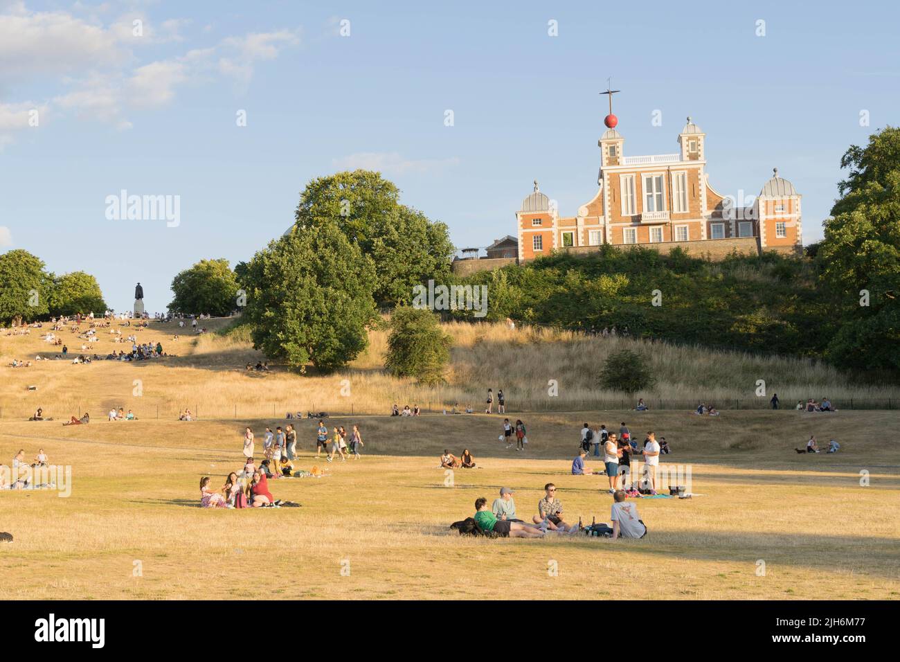 London UK, 15th July 2022.  UK Weather.  General public flock to Greenwich park to enjoy the hot summer Friday afternoon as sun rays  dries up the grass  in the park, An UK national emergency has been declared after a red extreme heat warning was issued for the first time, as temperatures could hit 40C next Monday, London England. Credit: Xiu Bao/Alamy Live News Stock Photo