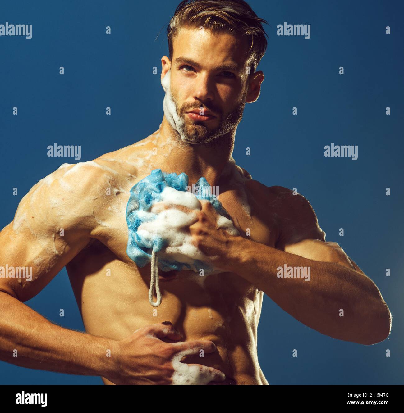 Handsome sexy muscular man take shower in bathroom. Morning washing. Hygiene, relax. Everyday life. Stock Photo