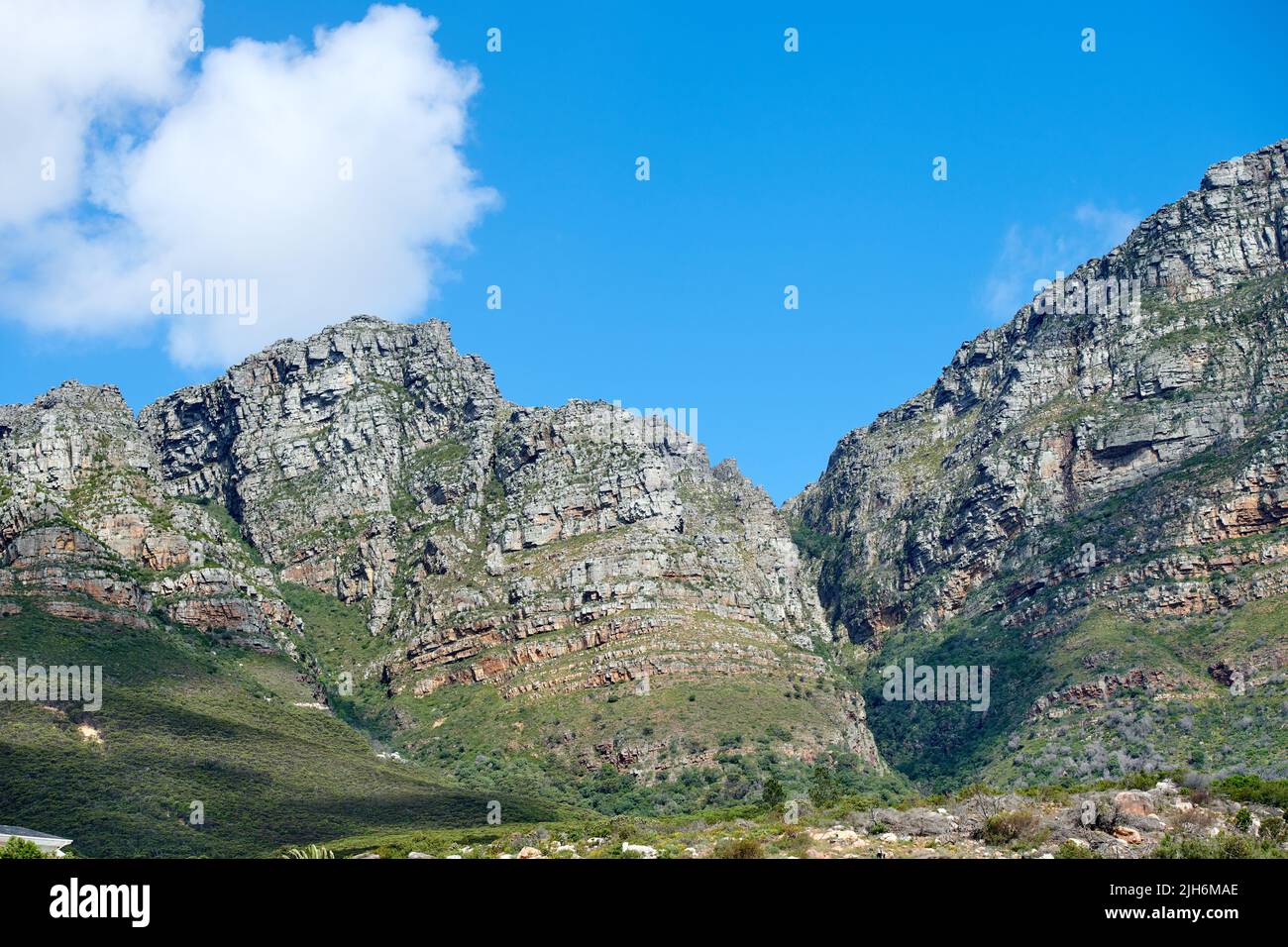 Scenic landscape of mountains in Western Cape, South Africa against a cloudy blue sky background with copyspace. Scenic of plants and shrubs growing Stock Photo