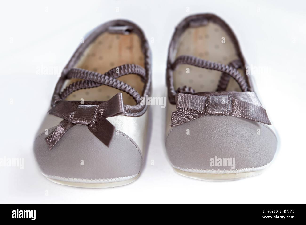 Cute pair of baby shoes for a little girl against a white background ...
