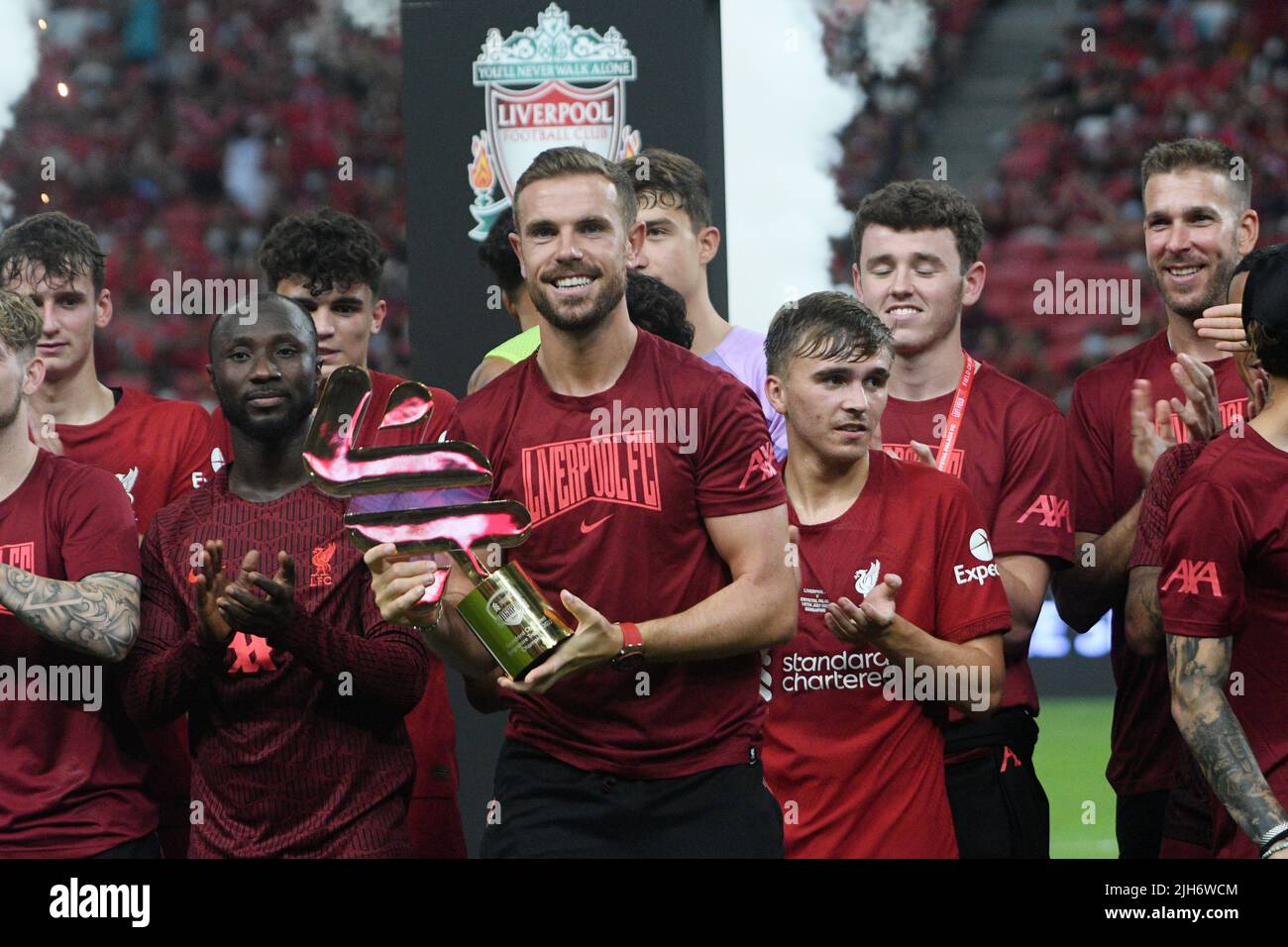 Singapore. 15th July, 2022. Jordan Henderson (front) of Liverpool holds the trophy after the Singapore Trophy 2022, the pre-season exhibition match between Liverpool FC and Crystal Palace FC held at Singapore's National Stadium on July 15, 2022. Credit: Then Chih Wey/Xinhua/Alamy Live News Stock Photo