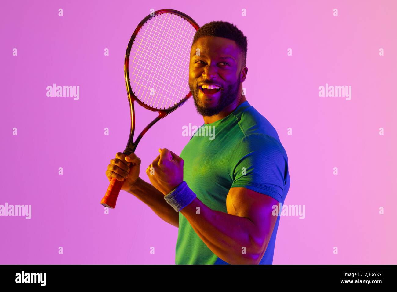 Image of successful african american male tennis player in neon violet