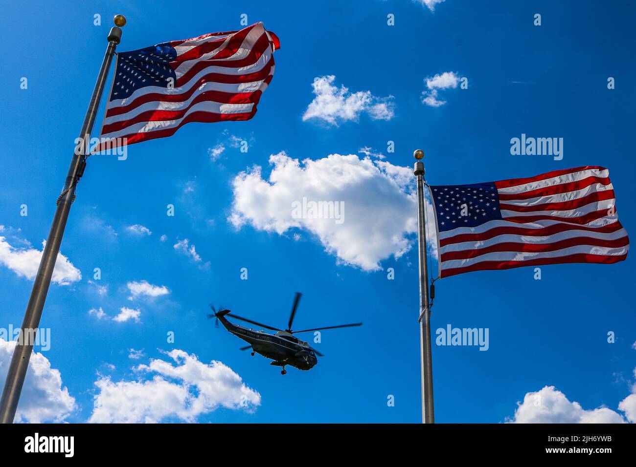 Marine One-style HMX-1 helicopter flies above American flags in Washington, DC, USA. Stock Photo