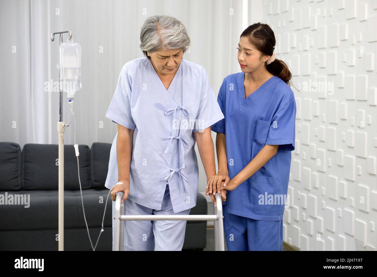 Young asian nurse at nursing home take care disabled senior woman