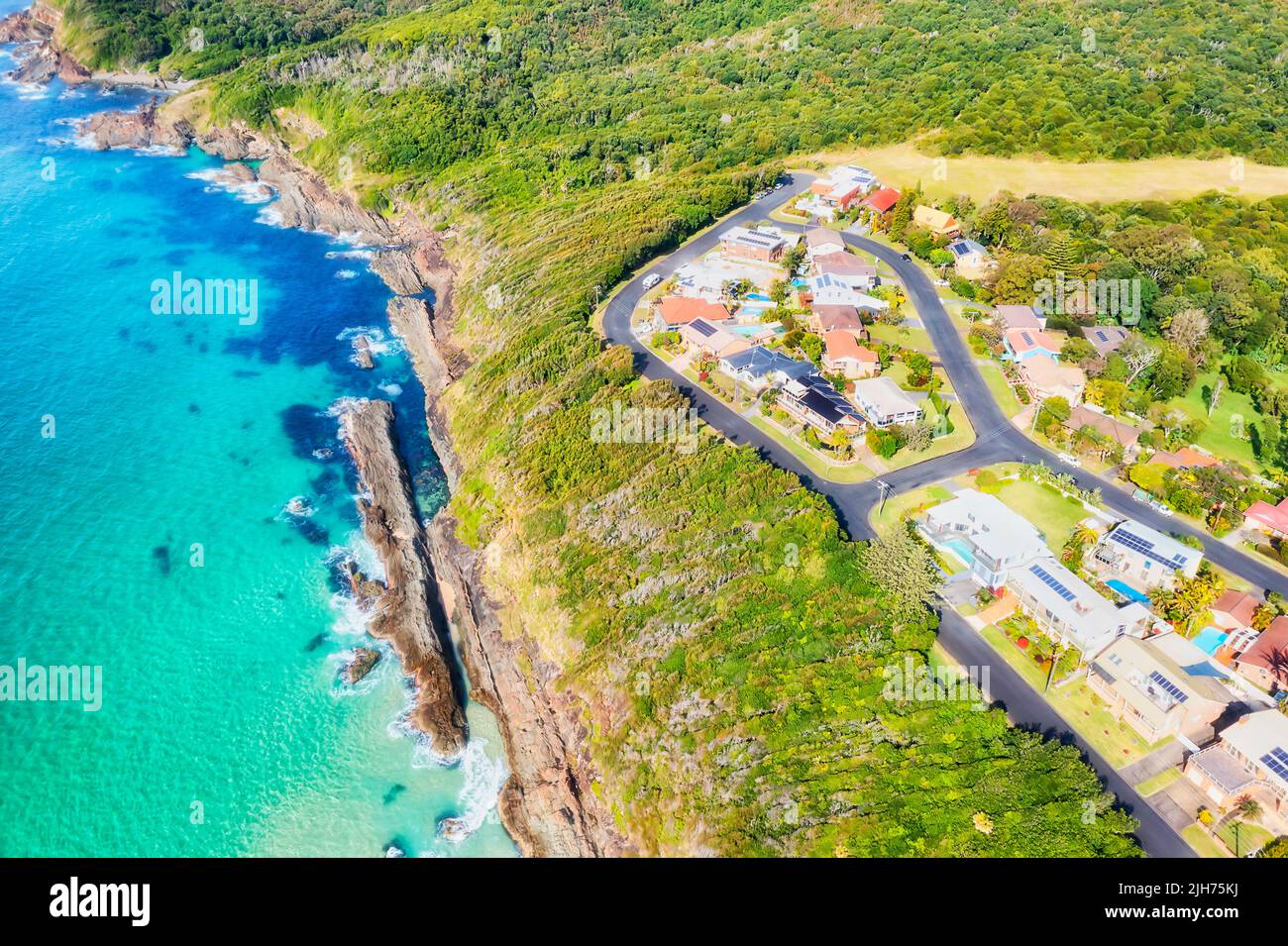 Cliff edge at Burgess beach and Hawke headland cape in Forster town of Australian Pacific coast  - aerial top down view. Stock Photo