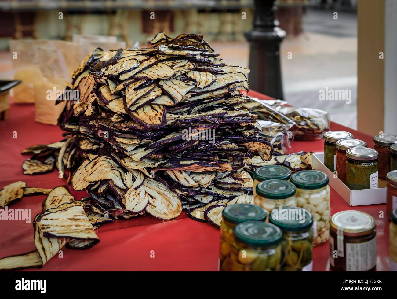 A heap of fresh locally grown dried grilled eggplant for sale at a local outdoor farmers market in Nice, French Riviera, South of France Stock Photo