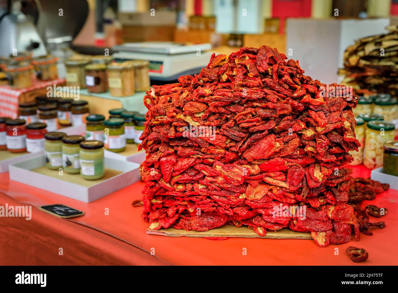 A heap of fresh locally grown sun dried tomatoes for sale at a local outdoor farmers market in Nice, French Riviera, South of France Stock Photo