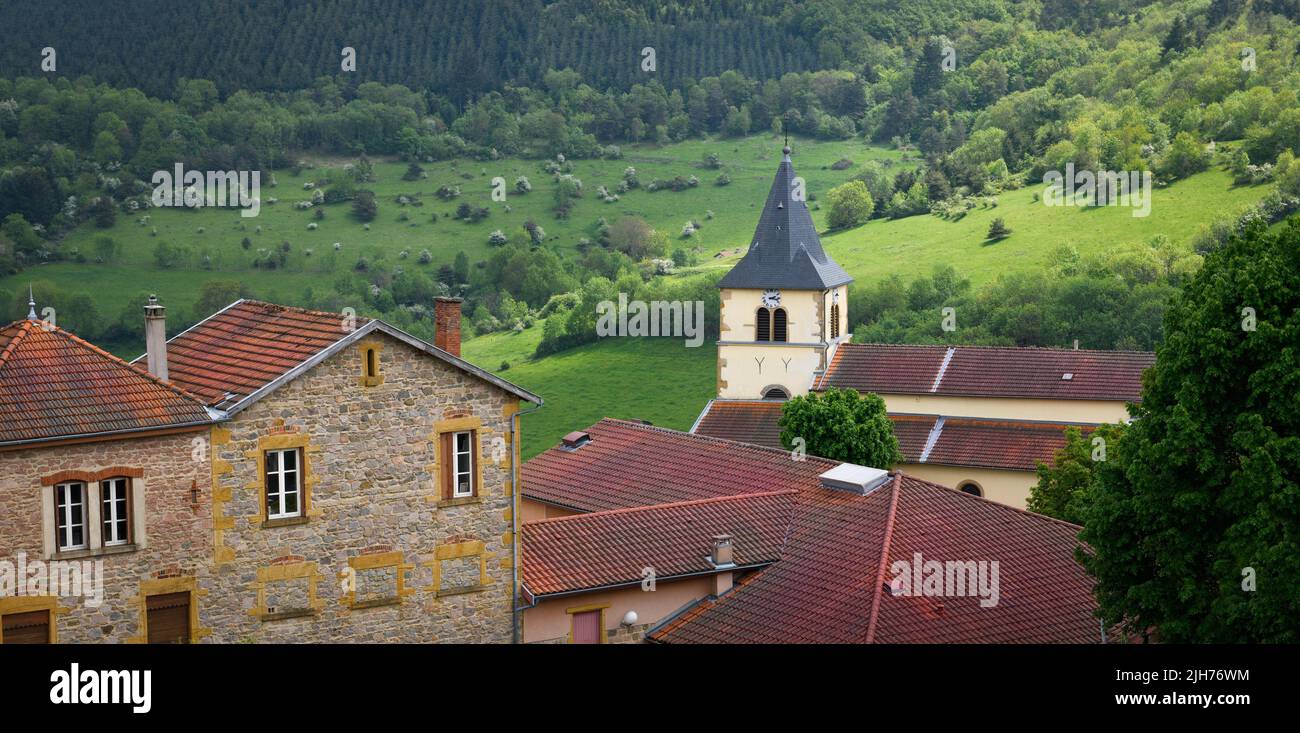Typical village in the french countryside by spring with green grass and natural hills Stock Photo