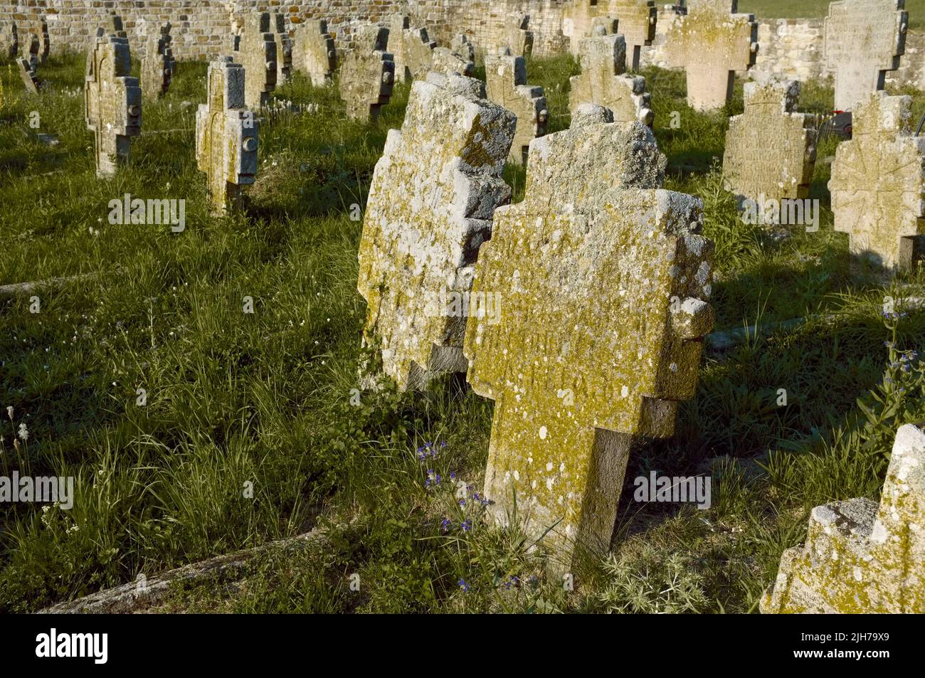 old gravestones in a graveyard of a medieval church in Serbia Stock Photo