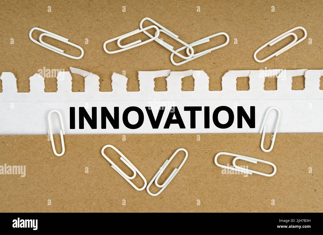 Business concept. On cardboard, white paper clips and a sheet from a ...