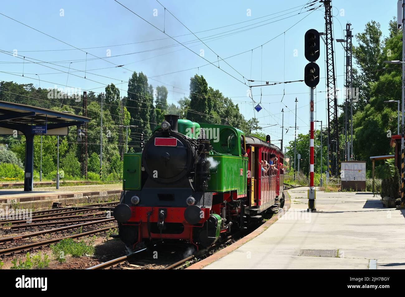 Beautiful old Czech train with steam locomotive. Concept for retro, travel and train travel. Train tracks and a cruise train in the countryside. Stock Photo