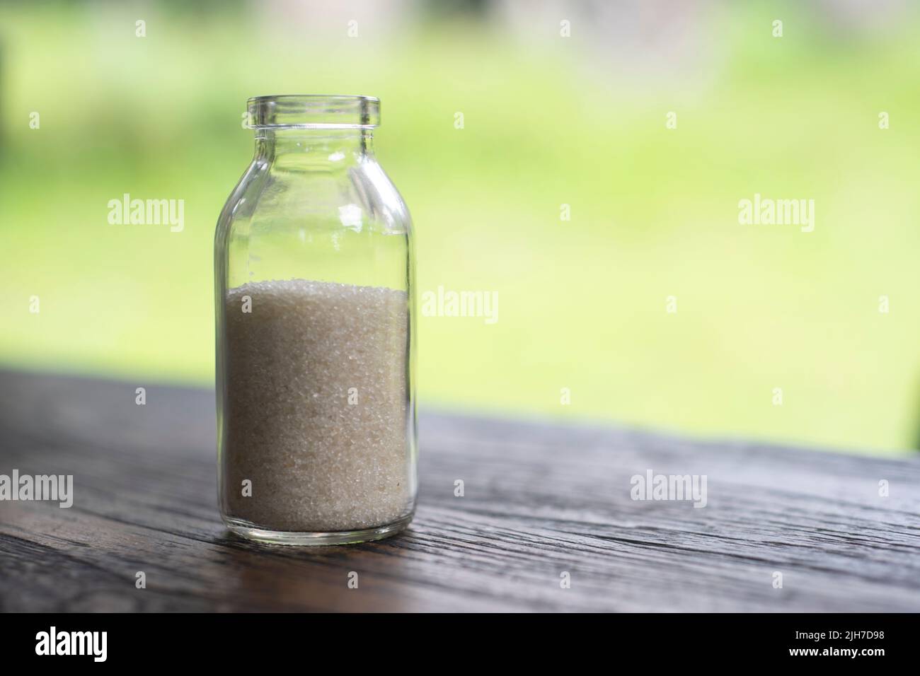 Sugar in the bottle on blur background Stock Photo Alamy