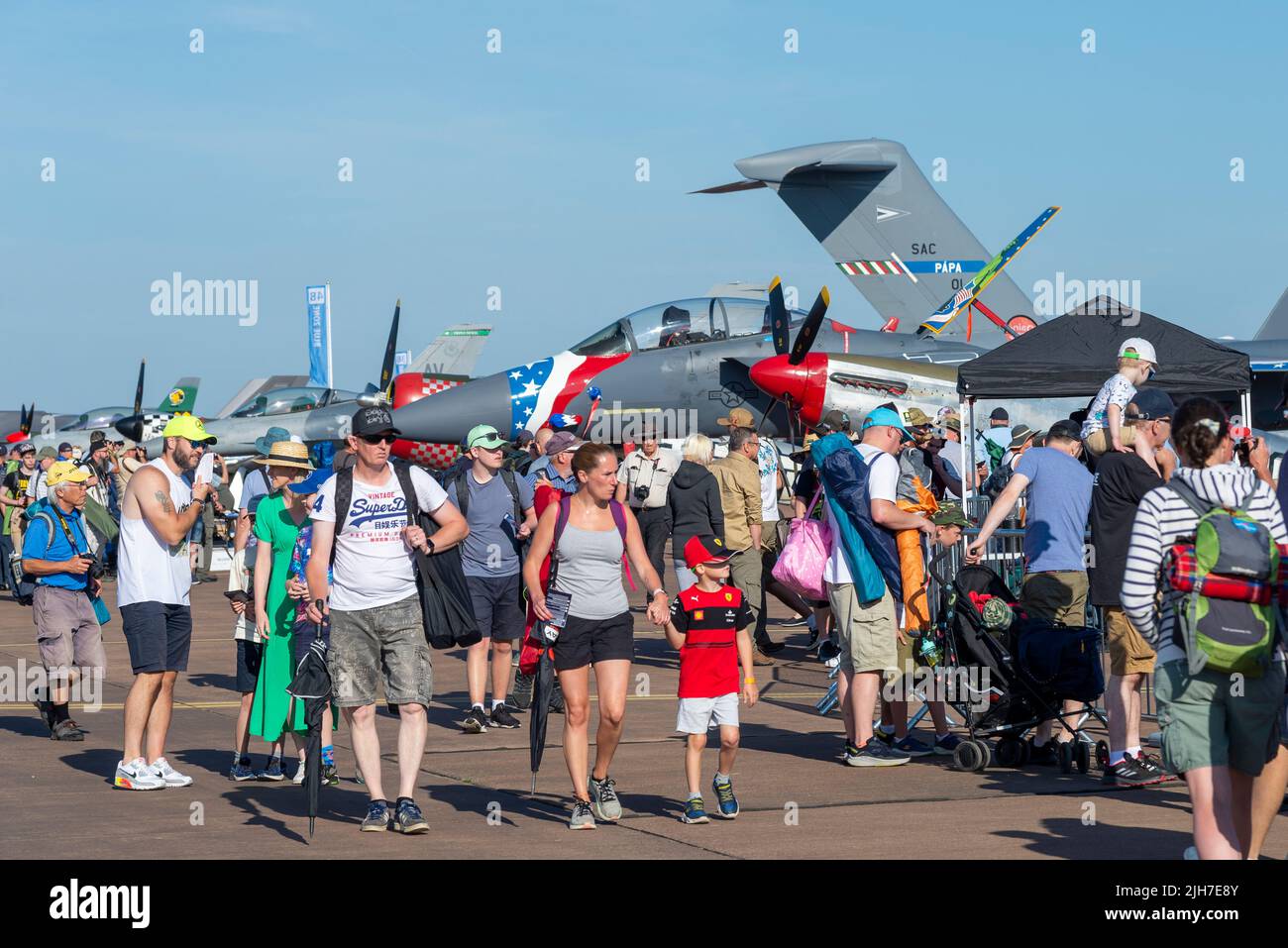 RAF Fairford, Gloucestershire, UK. 16th Jul, 2022. One of the world’s largest airshows has returned after a 3 year break due to the covid pandemic bringing international air forces, display teams and huge crowds to the Cotswolds. Families around the military planes on display Stock Photo
